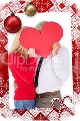 Composite image of handsome man getting a heart card form wife