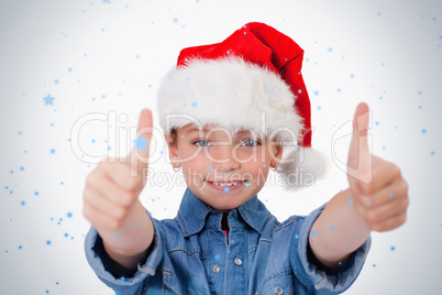 Girl with a christmas hat and the thumbs up