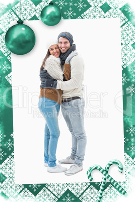 Composite image of attractive young couple in warm clothes hugging