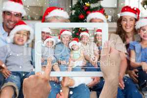 Composite image of hand holding tablet pc