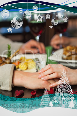 Close up on couple holding hands during dinner