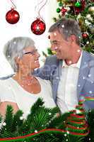 Composite image of senior couple in love in christmas