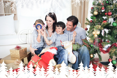 Composite image of happy family having fun with christmas presen