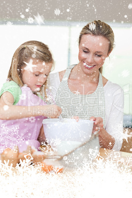 Smiling mother and daughter preparing dough for cookies