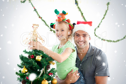 Happy father and daughter decorating together the christmas tree