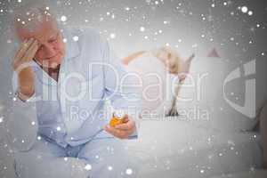 Composite image of old man looking at pills