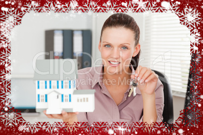 Businesswoman shows keys and model house