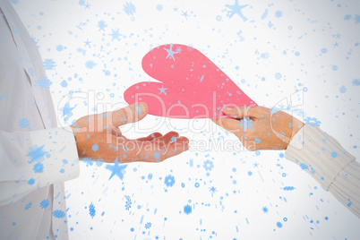 Woman handing man a paper heart