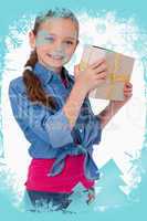 Composite image of portrait of a happy girl holding a gift box