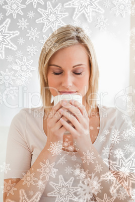 Woman smelling her cup of coffee