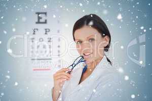 Composite image of kind female optician with an eye test