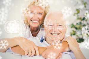 Composite image of happy old couple portrait hugging
