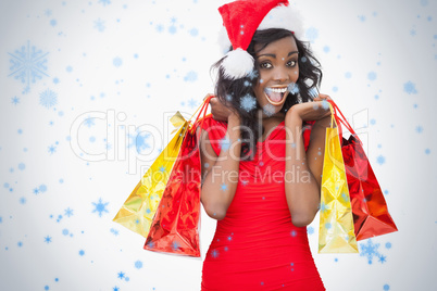 Composite image of woman standing holding bags