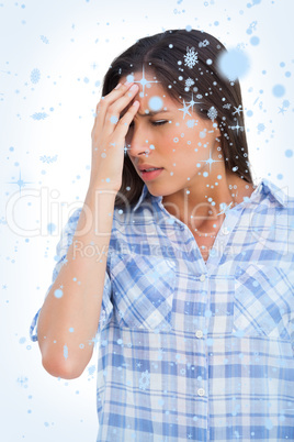 Composite image of woman with a headache and hand on forehead