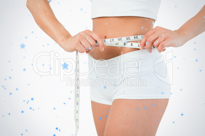 Feminine body with a measuring tape