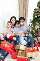 Composite image of happy family with lots of christmas presents