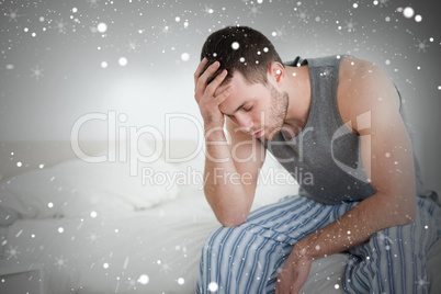 Composite image of exhausted man sitting on his bed