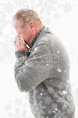 Sick mature man blowing his nose