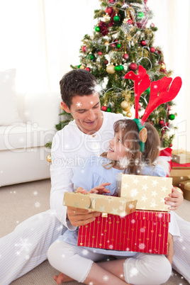 Composite image of smiling father and his daughter opening chris
