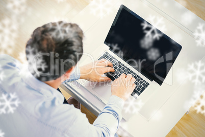 High angle view of casual man using laptop High angle view of casual man using laptop