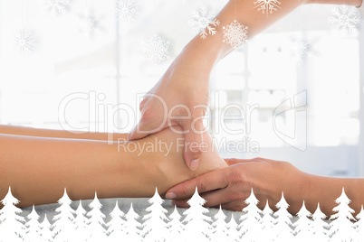 Woman receiving leg massage at spa center