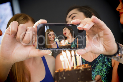 Composite image of hand holding smartphone showing