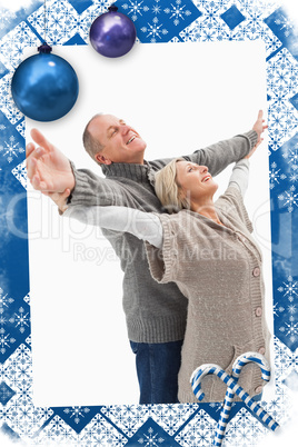 Composite image of happy mature couple in winter clothes