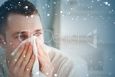 Composite image of sick man blowing his nose