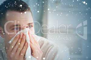 Composite image of sick man blowing his nose