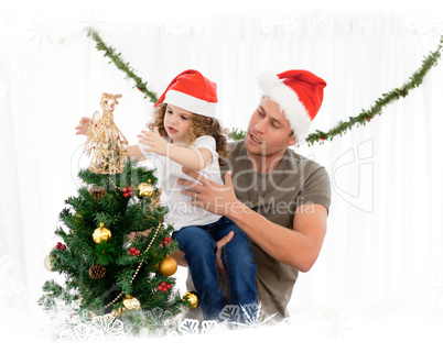 Cute daughter decorating the christmas tree with his father