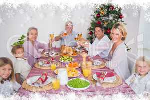 Composite image of family raising their glasses at christmas