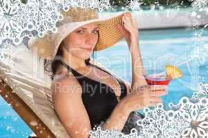 Beautiful woman holding drink by swimming pool
