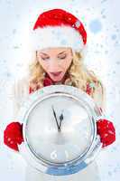 Festive blonde holding large clock