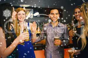 Composite image of happy friends holding beers