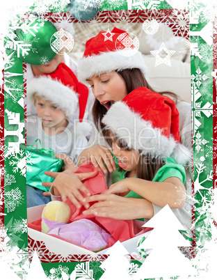 Cute little girl opening a christmas present with her mother