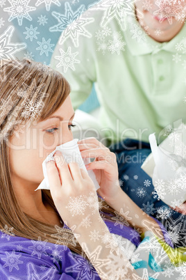 Sick woman with tissue lying on a sofa