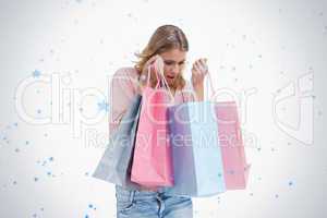 A woman is carrying shopping bags