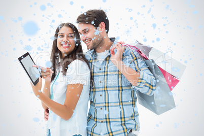 Composite image of attractive young couple with shopping bags an