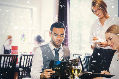 Composite image of two business people ordering dinner