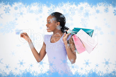 Woman with her shopping and credit card on white background