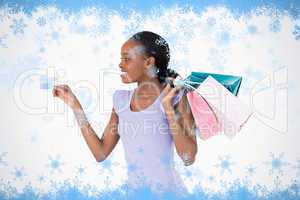 Woman with her shopping and credit card on white background