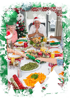 Cheerful family at dining table for christmas dinner