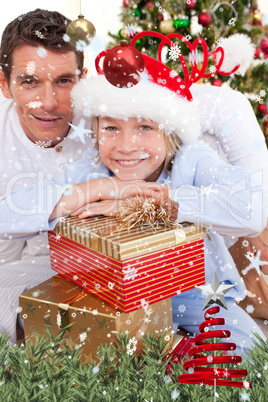 Portrait of a father and his son holding christmas presents