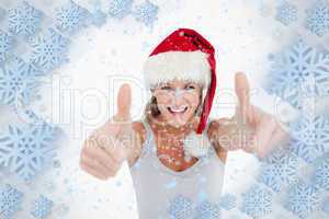 Woman with the thumbs up and a christmas hat