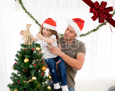 Cute daughter decorating the christmas tree with his father