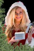 Pretty blonde in santa outfit opening gift