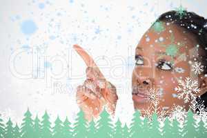 Close up of woman pointing at something next to her on a white background