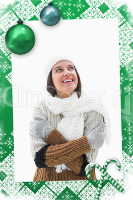 Composite image of pretty brunette in warm clothes