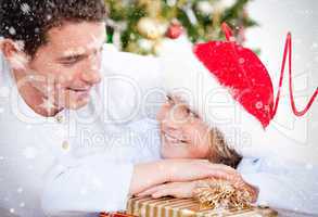 Composite image of attractive father celebrating christmas with