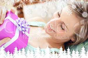 Composite image of happy woman holding a present